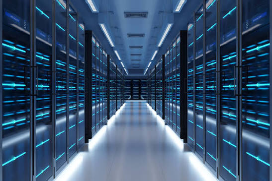 Rows of illuminated server racks inside a hyperscale data center hall